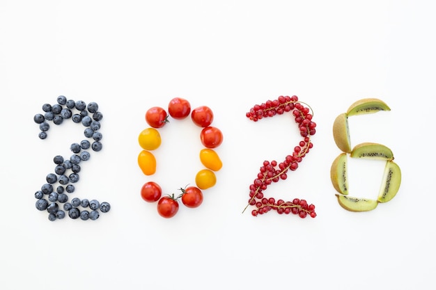 New year 2026 made of fruits on the white background Healthy food