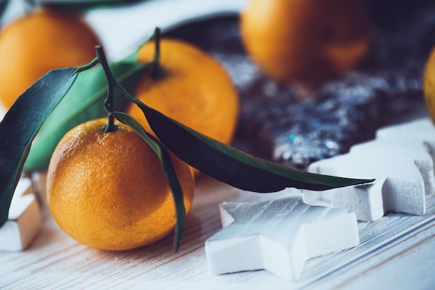 Photo new year background - appetizing tangerines close-up  on the table