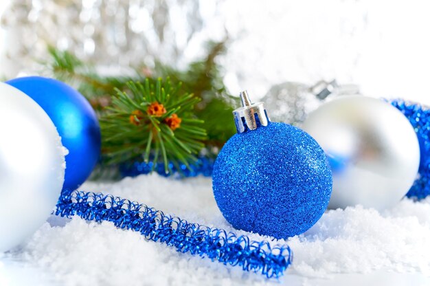 New Year background with blue and silver Christmas balls in snow