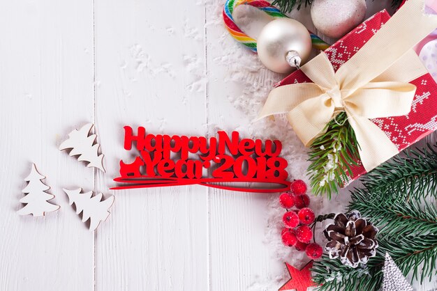 Photo new year background with gift boxs, christmas tree, mittens and decorations