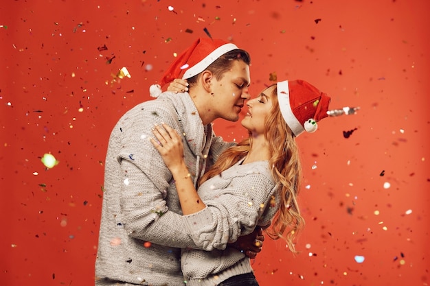 New year beautiful couple kissing with confetti