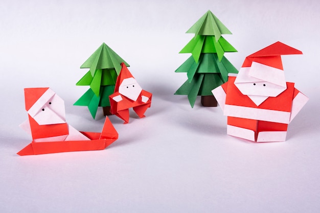 New Year card handmade origami figures. Christmas concept winter crafted decorations studio shot ISOLATED santa claus origami