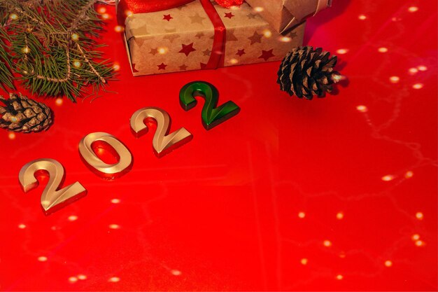 Concetto di celebrazione del nuovo anno con numeri e regali con spazio di copia su sfondo rosso
