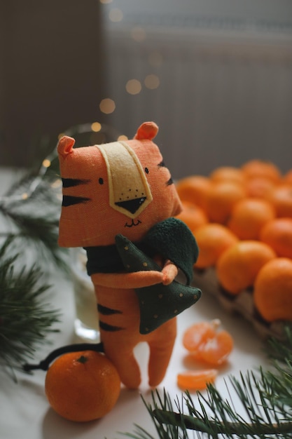 New year and christmas background with tangerines and tiger toy symbol of 2022