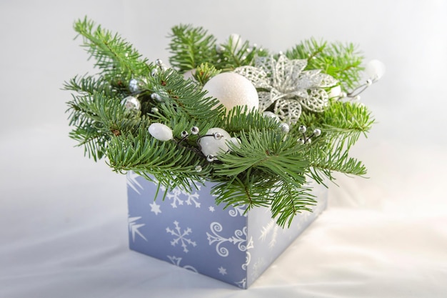 New year christmas decorations with pine cones and white balls in a blue box