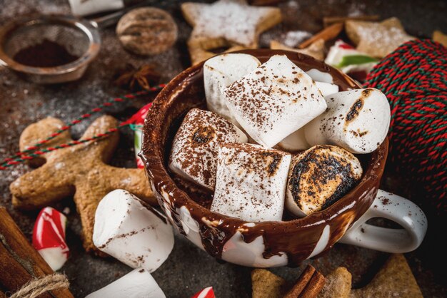 New Year, Christmas treats, sweets. Cup of hot chocolate with fried marshmallow, ginger star cookies