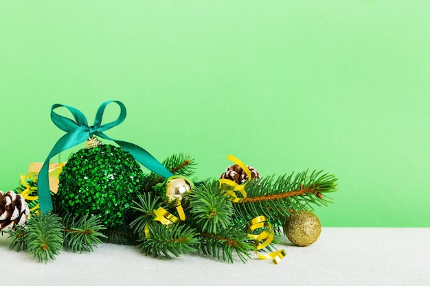 New Year Christmas tree toy branches of a christmas tree New Year decorations on a colored background