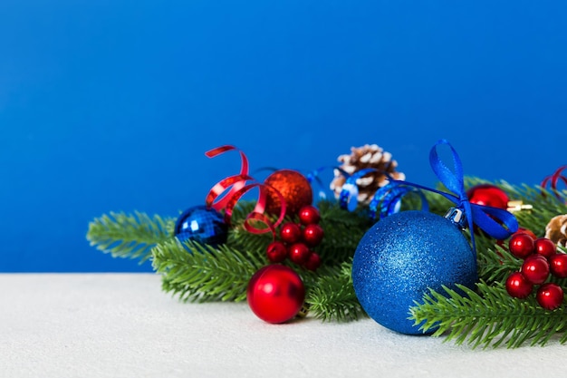 New Year Christmas tree toy branches of a christmas tree New Year decorations on a colored background