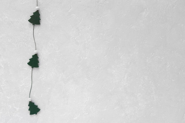 New Year and Christmas trees garland on grey background, copy space