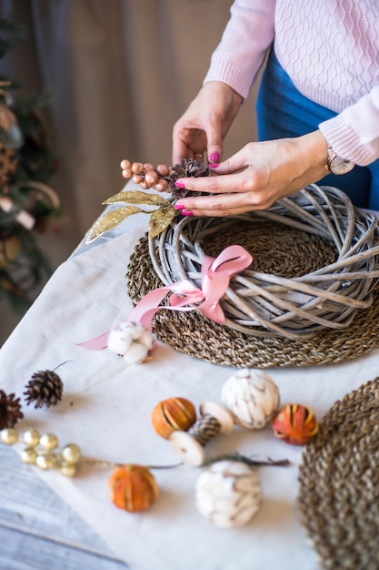 New year or Christmas wreath made of twigs cinnamon sticks cones and Christmas toys