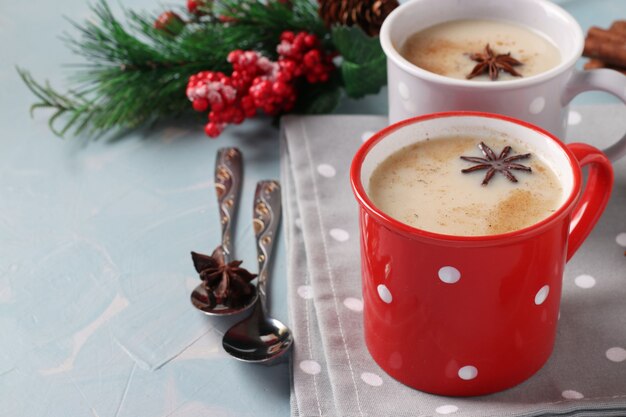 New Year composition with Indian Masala tea with spices in two cups on light blue