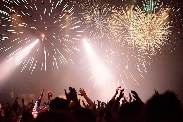 New Year concept cheering crowd and fireworks