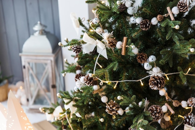 New year cozy home interior with christmas tree and garlands