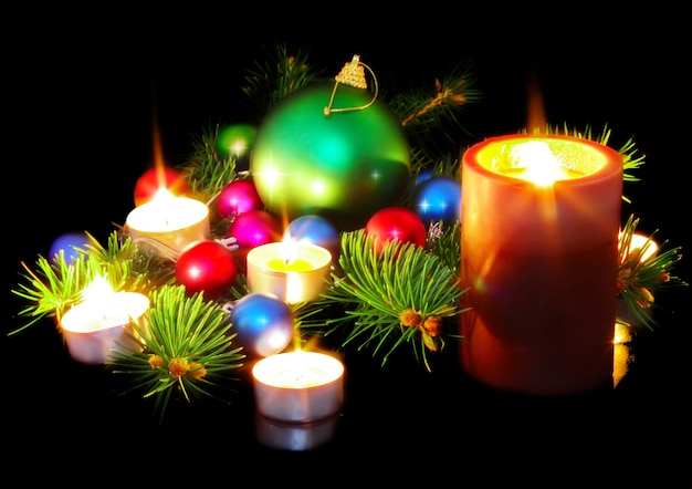 New Year decoration- balls, tinsel, candel .On black background