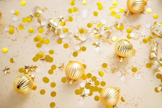 New year decorations golden color with confetti on color background