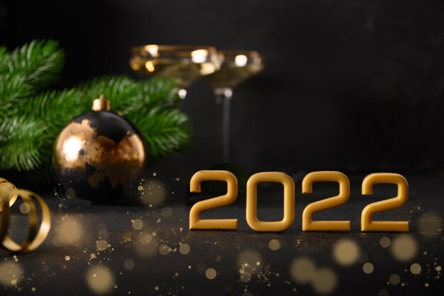 New year  festive composition with number of year  gift baubles gift and wine glasses