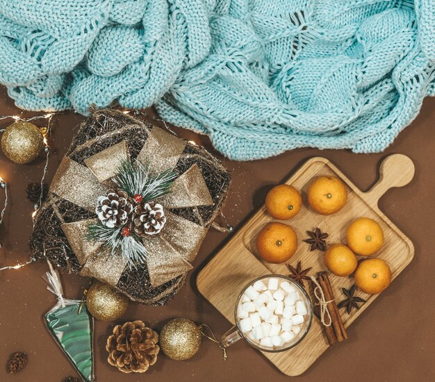 New Year flat lay with golden gift,balls,lights,cones,cinnamon and anice star,caramel .