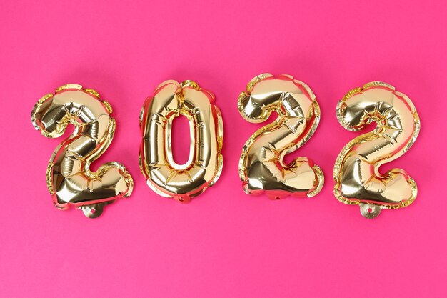 New year  foil balloons numbers  on pink background new year christmas