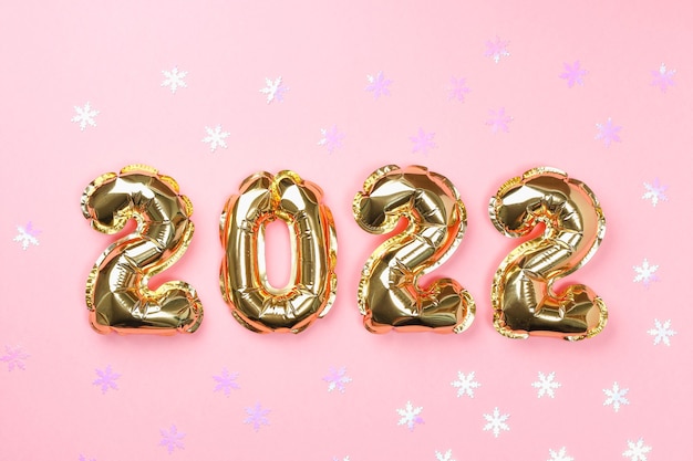 New year  foil balloons numbers  on pink background new year christmas