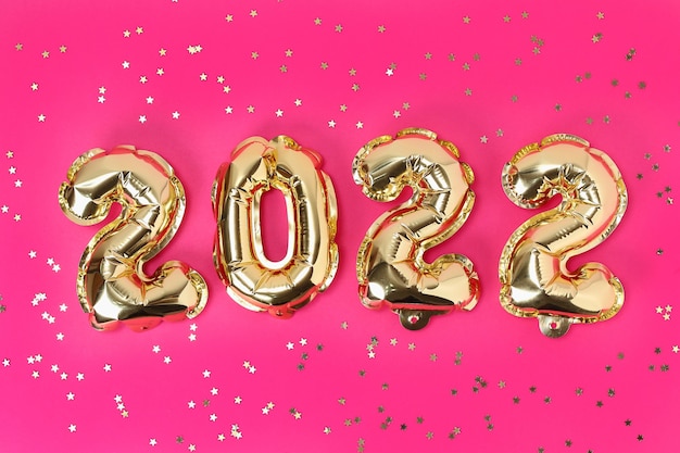 New year foil balloons numbers on pink background