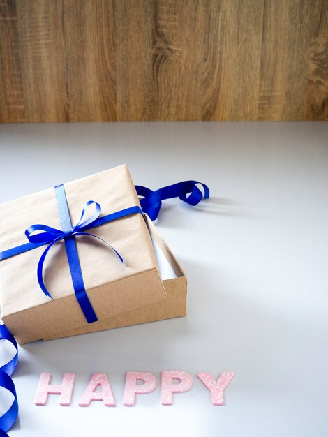 New Year gift box made of ribbon tied with blue ribbon.