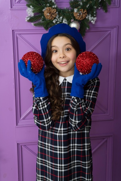 new year has just begun happy new year cheerful parisian girl in beret and gloves winter activity season shopping small french girl stylish kid decorative ball decorate home and christmas tree