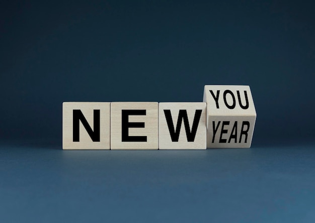 Photo new year new you cubes form words new year new you concept of new life from scratch habits goals and motivation in life or business