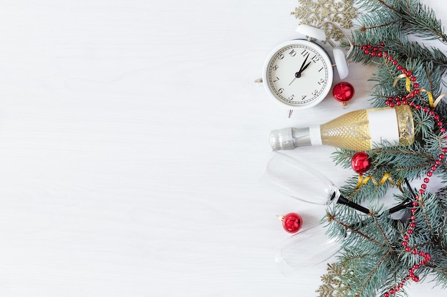 New Year's background with champagne bottle fir branches and Christmas decorations