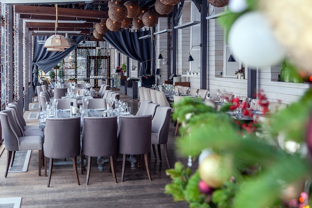 New Year's Christmas interior veranda modern restaurant setting, serving banquet.