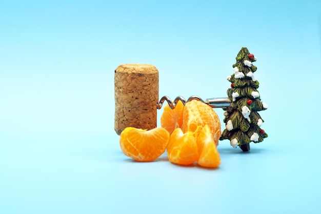 New year's composition of tangerines corkscrew and cork