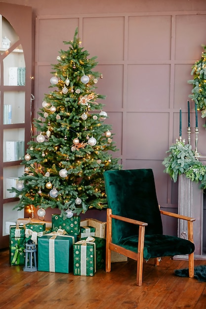 New Year's decor in green colors, a festive tree with gifts