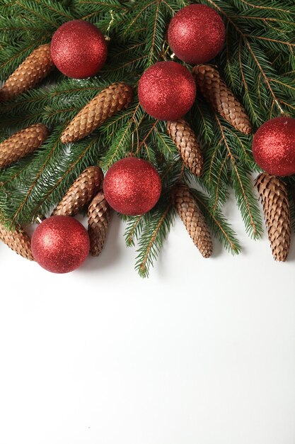 New Year's Eve background with fir branch and cones.