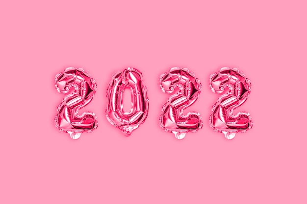 New Year's golden pink balloons celebration banner. New Year and Xmas concept. Flat lay, top view.