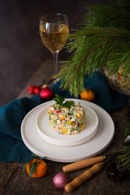 New Year's holiday salad with mayonnaise, New Year's table, champagne, copy space