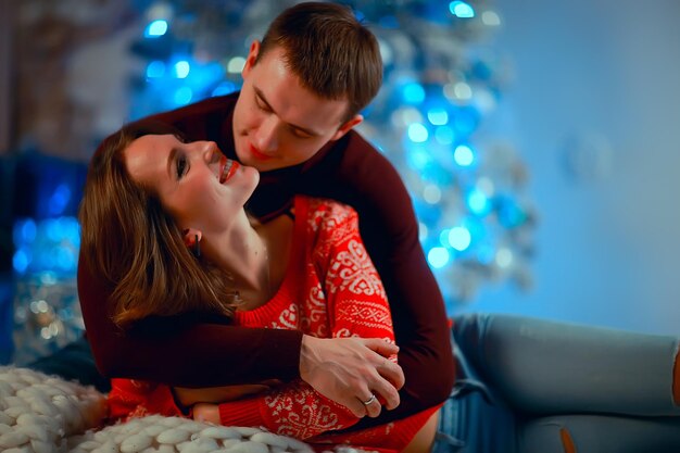 New Year's photo people / young man and girl in the Christmas interior, cozy decorated house