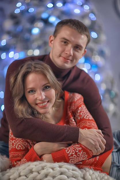 New Year's photo people / young man and girl in the Christmas interior, cozy decorated house