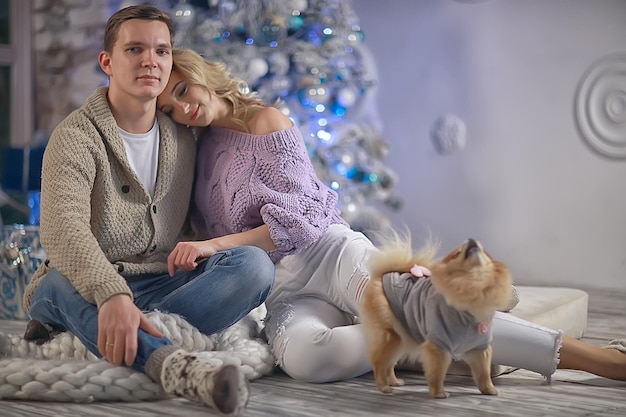 New Year's photo people / young man and girl in the Christmas interior, cozy decorated house