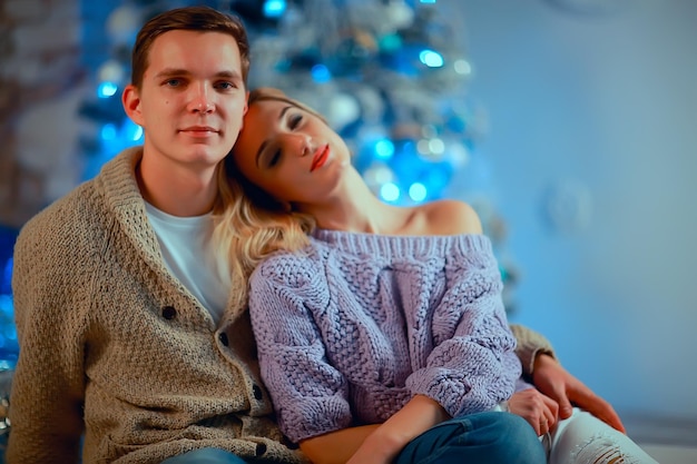 New Year's photo people / young man and girl in the Christmas interior, cozy decorated house