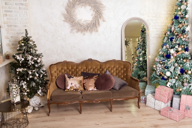 New Year's photo studio with a Christmas tree, decorations and a sofa