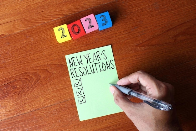 New Year's resoluties concept Houten kubussen met nummer 2023 en tekst NEW YEAR'S RESOLUTIES
