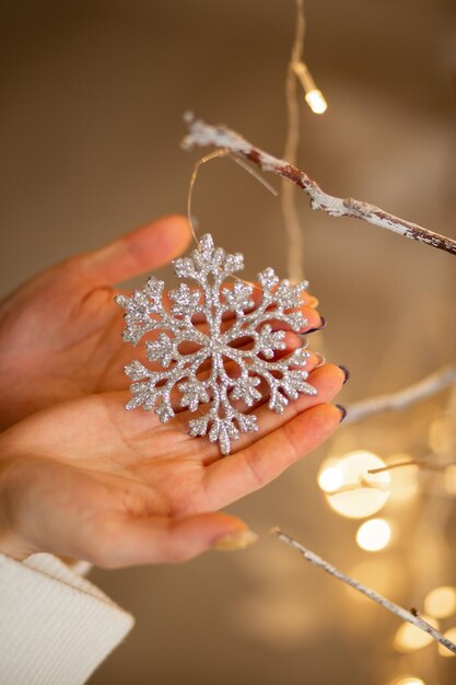 New Year's toy snowflake in the hands of a girl 2023 is the year of the rabbit Christmas is coming