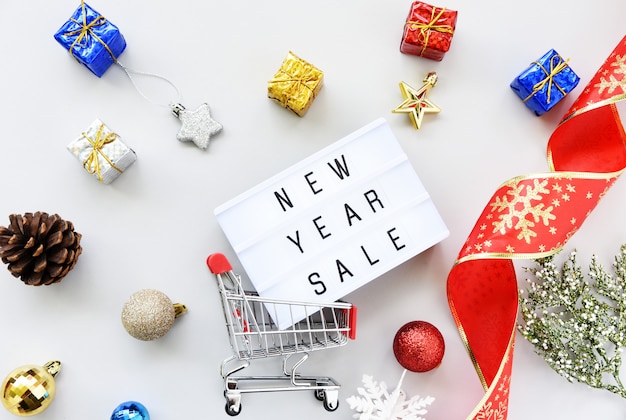 new year SALE text on lightbox composition and Christmas decorations