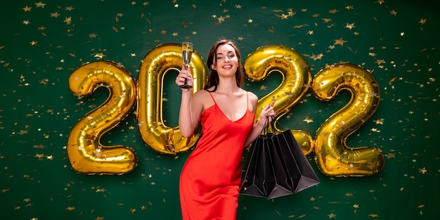 New year shopping black friday  air balloons woman with champagne and purchases celebrate