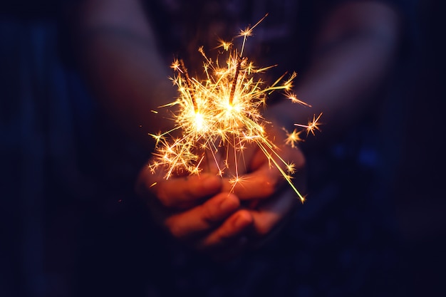 New year sparkler in woman hands. 