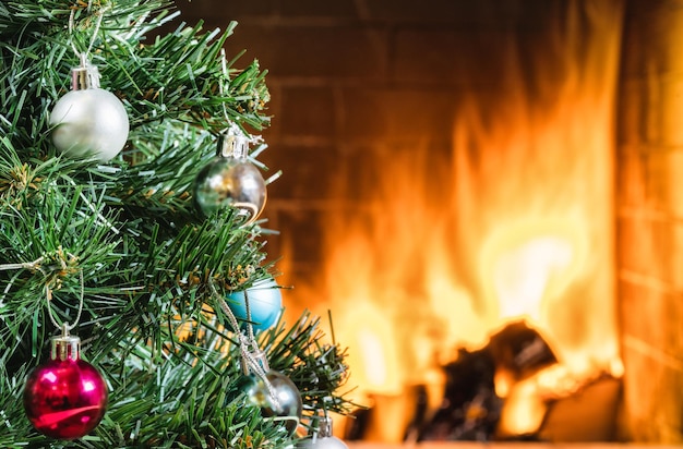 New year tree near cozy fireplace in country house