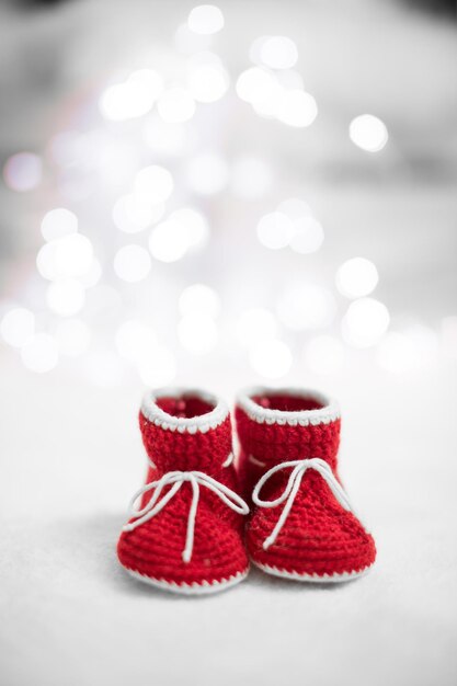 New year written laces of children's shoes and pacifier on old wooden background Toned image