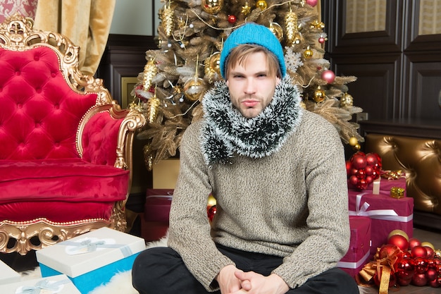 New year xmas eve party Boxing day concept Macho in hat sweater with wrapped presents Man