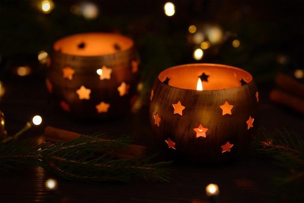 New Year39s decor in golden tones candlesticks with candles fir branches and a garland