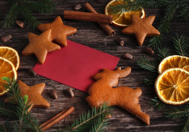 New Year39s layout with ginger cookies orange slices spruce branches and writing on a wooden background