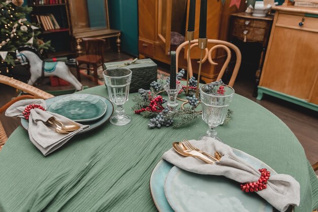 New Year39s table setting Christmas in the style of the new year39s fifties rustic antique style decorated apartment without food with plates candles and Christmas trees